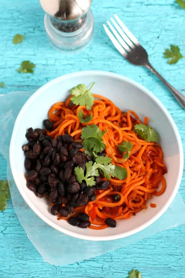 sweet potato noodles in a white bowl with black beans