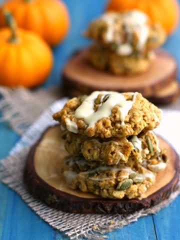 Soft and chewy gluten free and vegan pumpkin oatmeal cookies are topped with a white chocolate glaze. Delicious! #ad