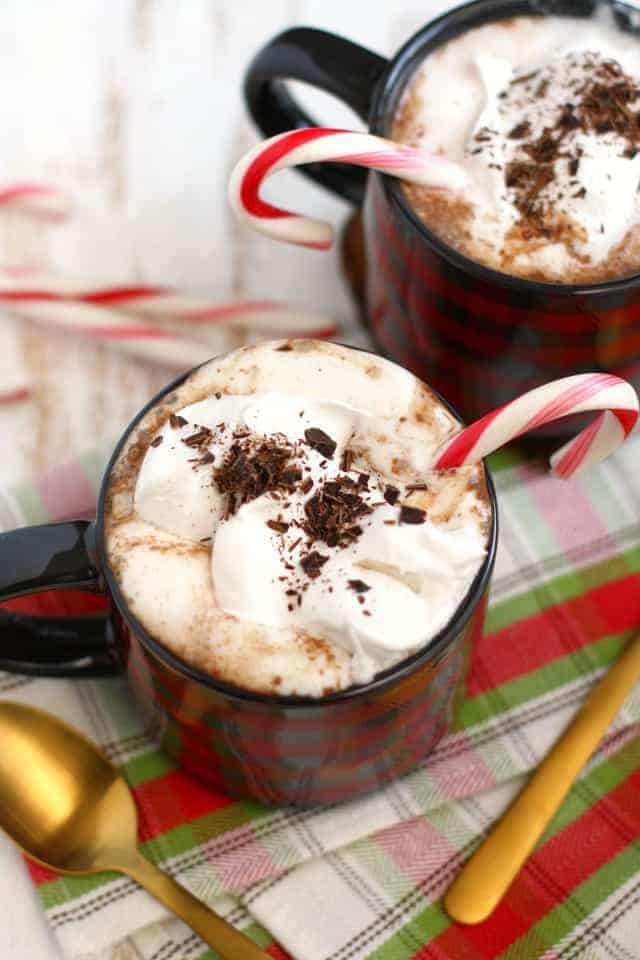 Dairy free peppermint hot cocoa in a mug with a candy cane