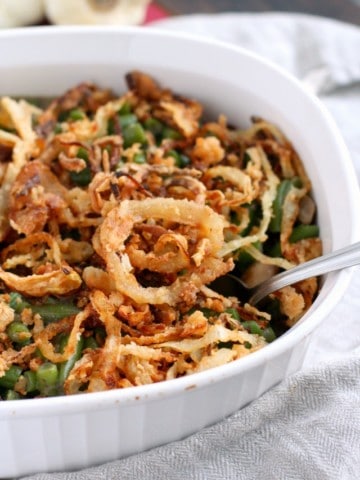 This delicious gluten free green bean casserole is topped with homemade french fried onions. Perfect for a holiday meal!