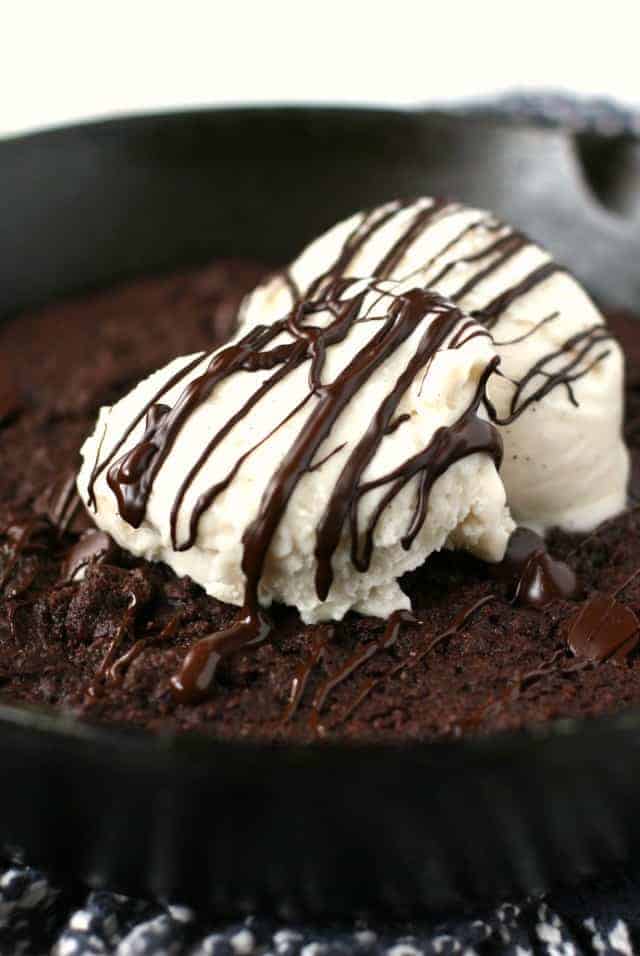 gluten free brownie in cast iron skillet with ice cream