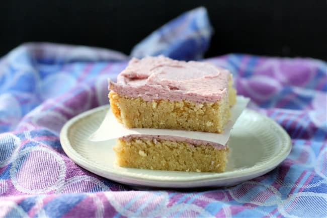 frosted sugar cookie bars on a plate