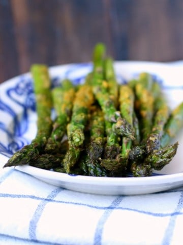 Fresh asparagus is coated with a cheesy, buttery topping - a tasty vegan side dish!
