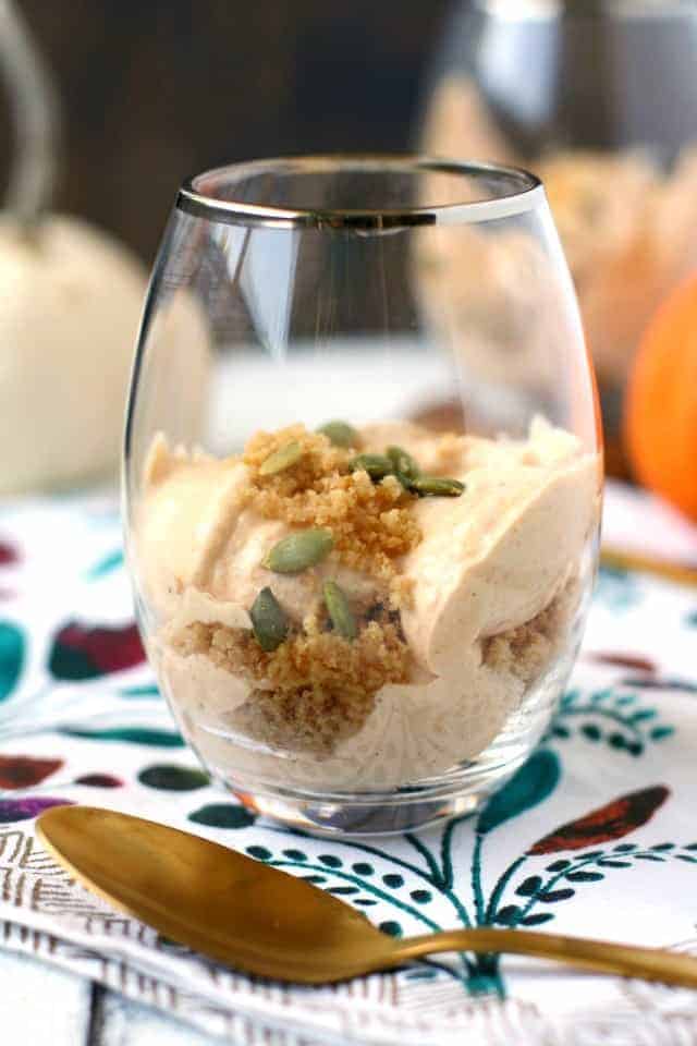 dairy free pumpkin mousse in a clear glass with a gold spoon