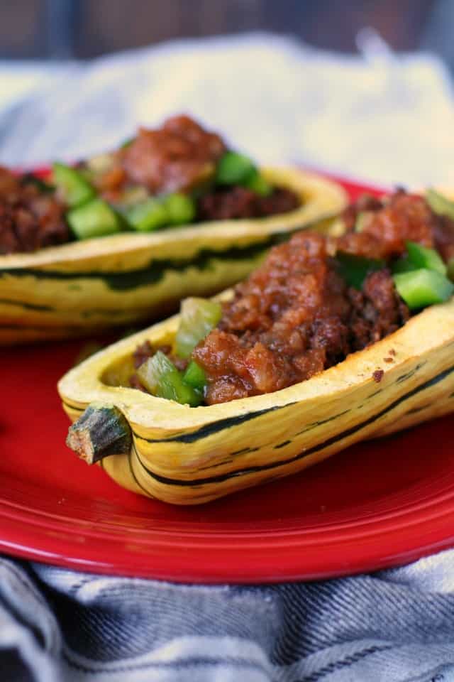 taco stuffed delicata squash on a red plate