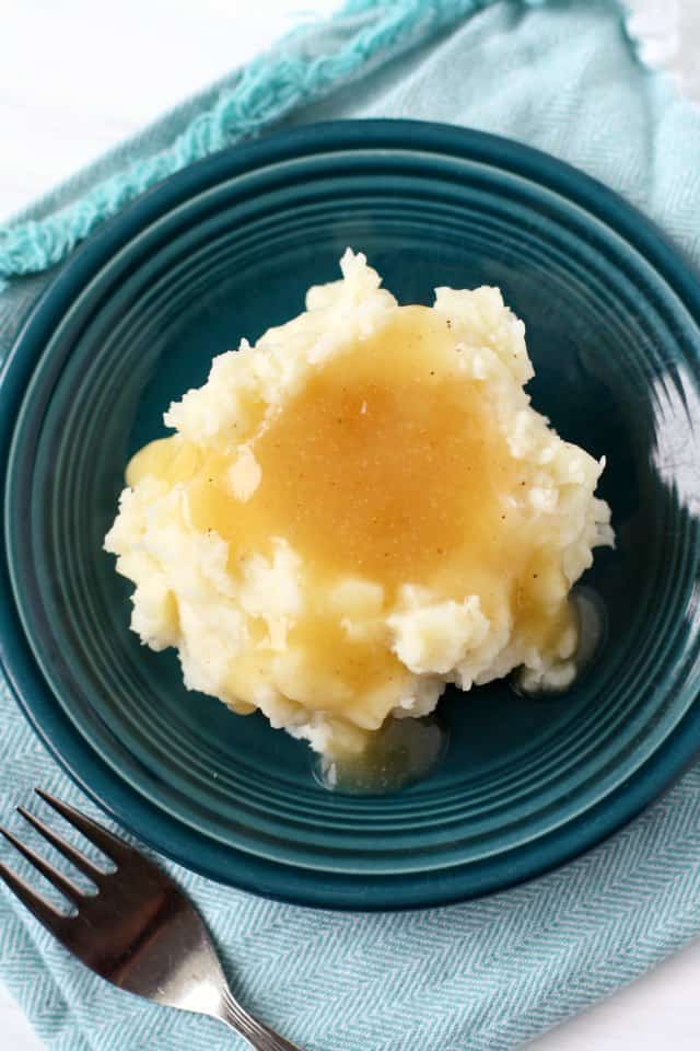mashed potatoes and gravy on a teal plate
