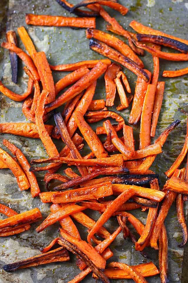 baked carrot fries on a cookie sheet