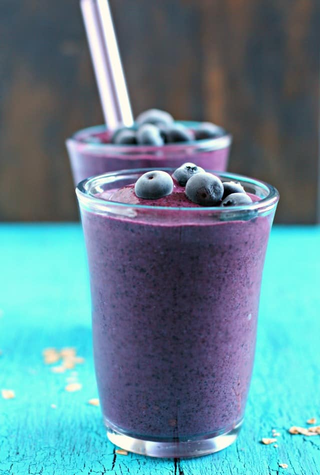 two blueberry oatmeal smoothies in clear glasses