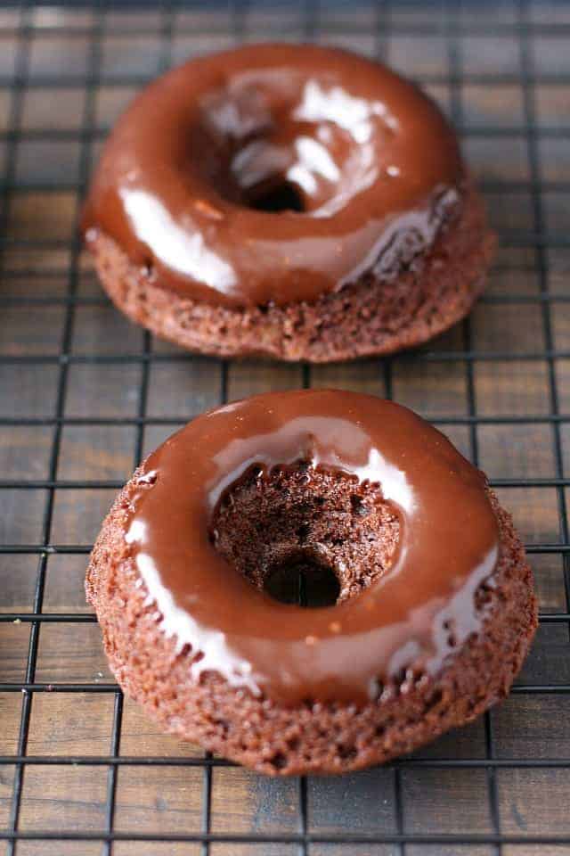 vegan chocolate gingerbread donuts on a cooling rack