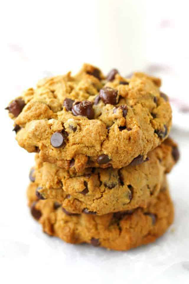stack of chocolate chip cookies on a white surface
