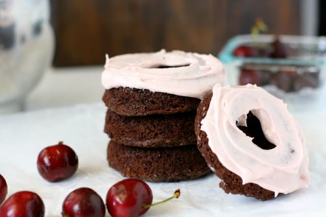 stack of choclate cherry donuts with cherries