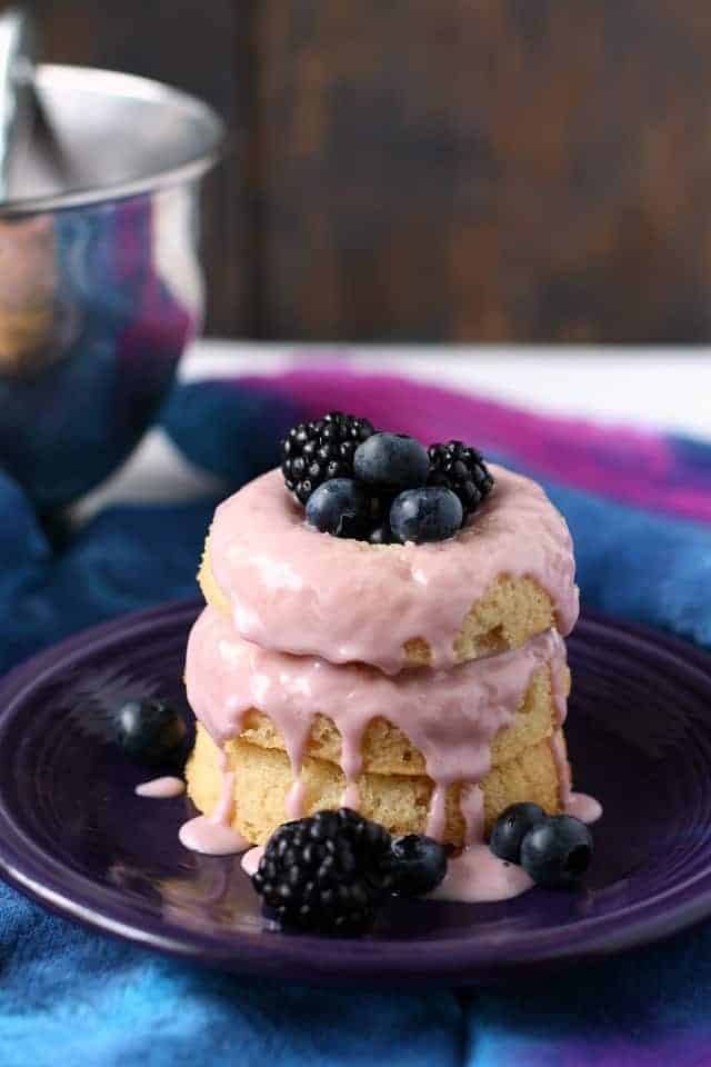 vegan donuts on a purple plate with blueberries