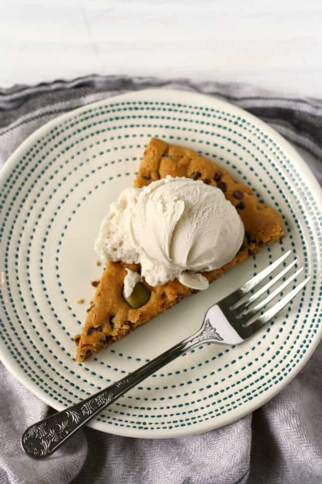 slice of giant chocolate chip cookie with ice cream