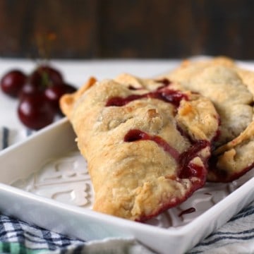 cherry hand pies on a white tray