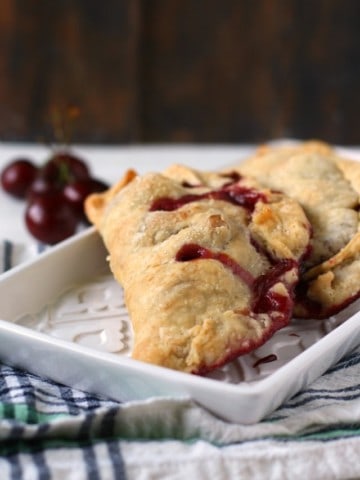 cherry hand pies on a white tray
