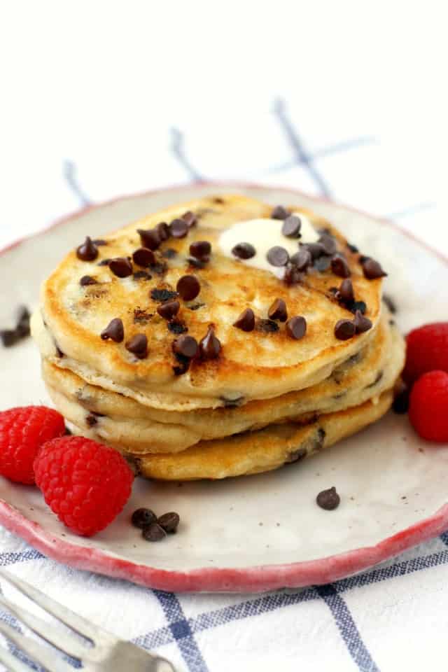egg and dairy free chocolate chip pancakes on a plate with berries