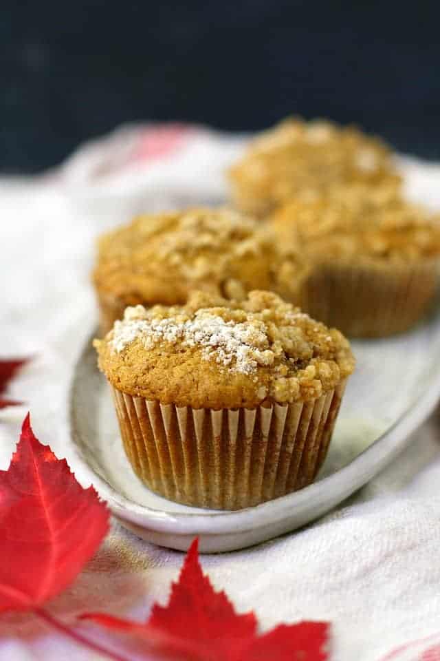 vegan pumpkin muffins with streusel on a white tray