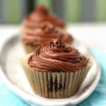 vegan chocolate frosting on a cupcake on a white tray
