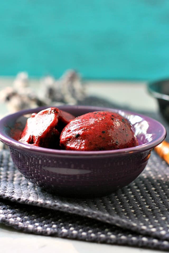 scoop of berry sorbet in purple bowl
