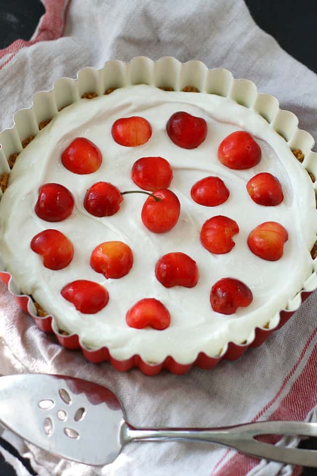 vegan cheesecake with fresh cherries on top
