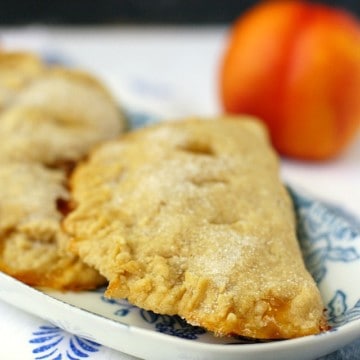 vegan peach hand pies on a floral plate