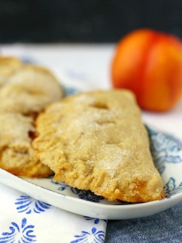 vegan peach hand pies on a floral plate