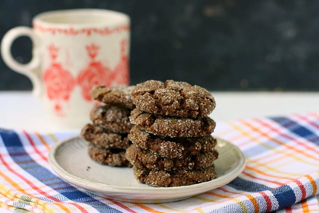 chewy chocolate crinkle cookies stacked on a plate