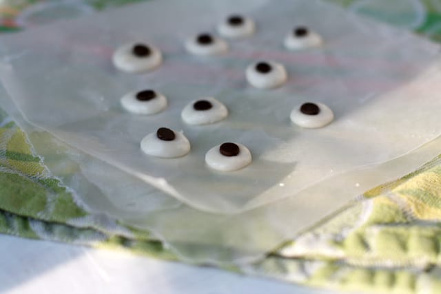 frosting googly eyes on wax paper