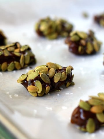 chocolate dipped dates on a cookie sheet