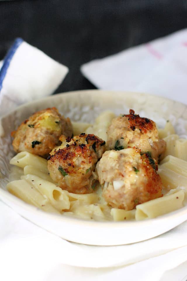chicken meatballs and creamy pasta in a white bowl