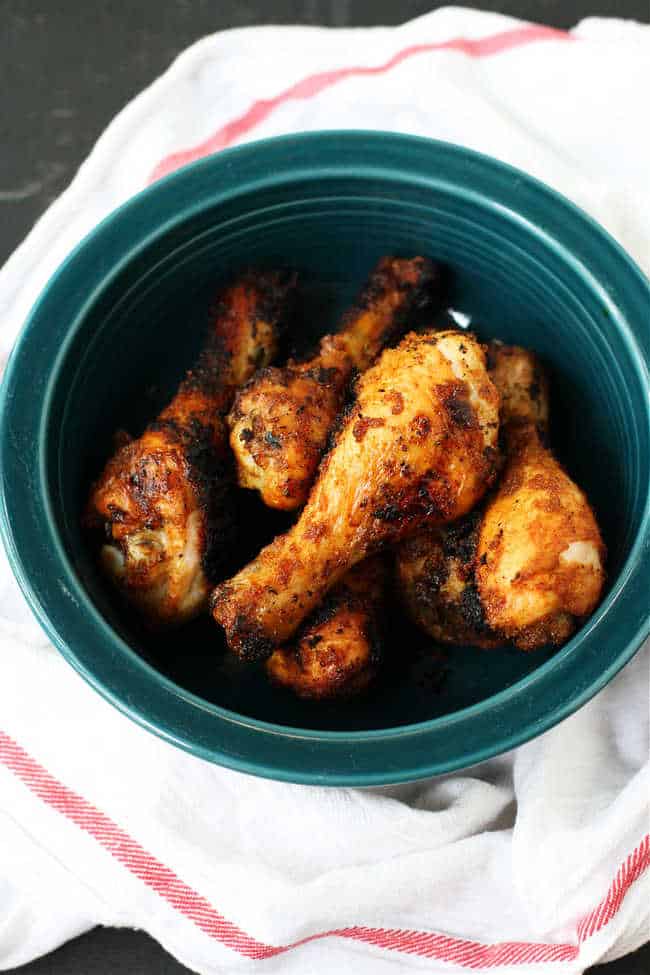 grilled chicken legs with spice rub in a serving bowl