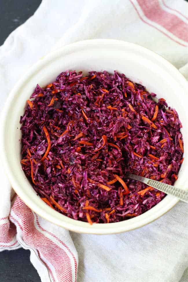 carrot and red cabbage cole slaw in a white bowl