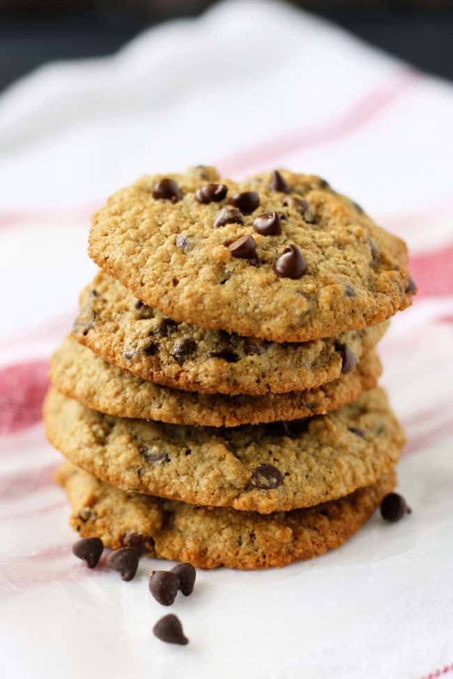 stack of chocolate chip oat flour cookies on a dish towel