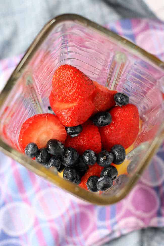 strawberries and blueberries in a blender