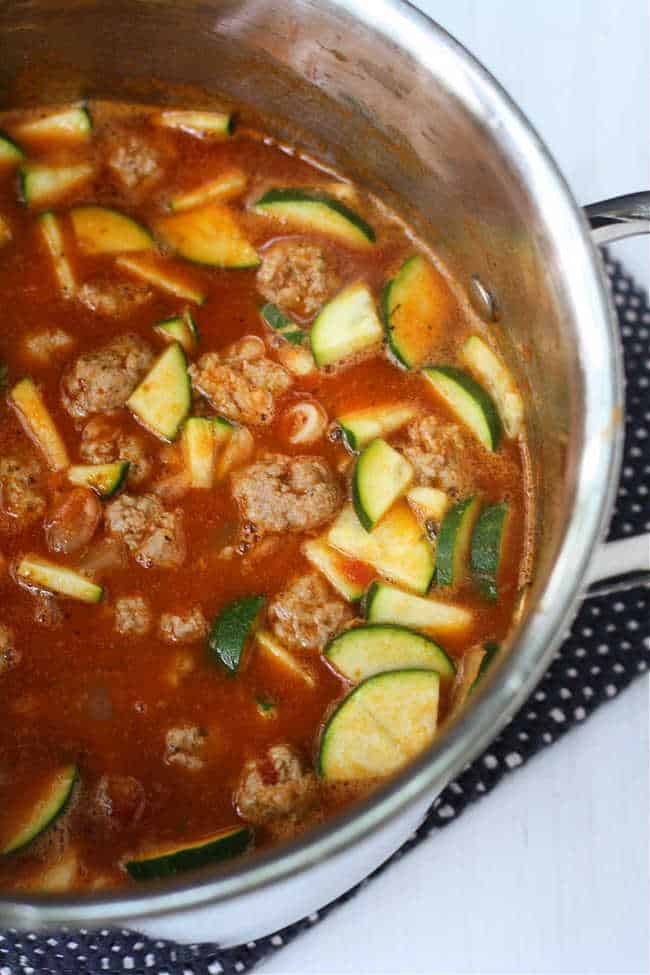 pot of italian meatball soup with zucchini and noodles