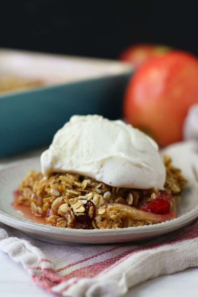 serving of apple cranberry crisp with a scoop of ice cream
