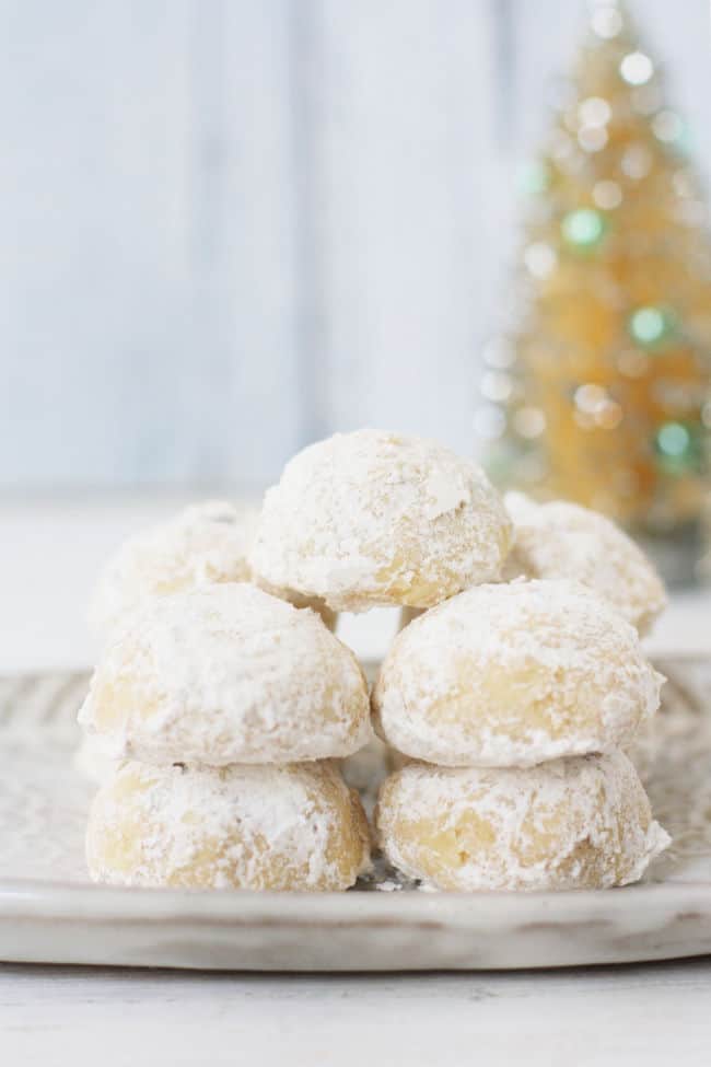 stack of gluten free snowball cookies on a white plate