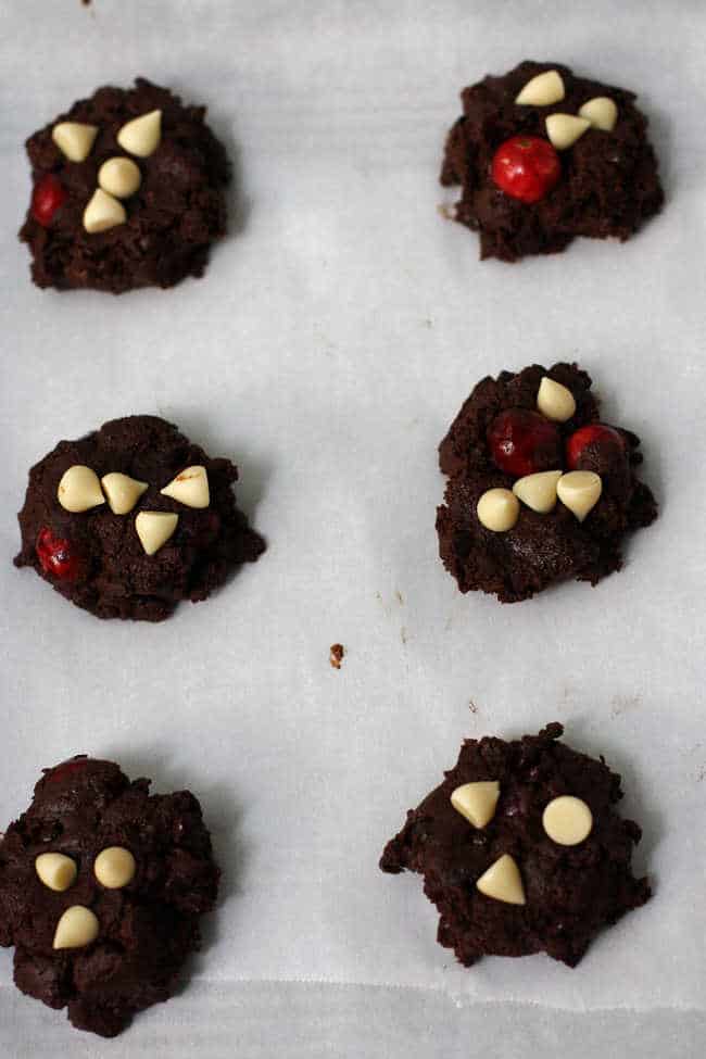 chocolate cranberry cookies on a cookie sheet