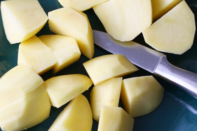 diced potatoes on a plate with a sharp knife