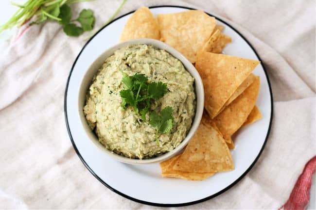 white bean dip with cilantro on a plate 