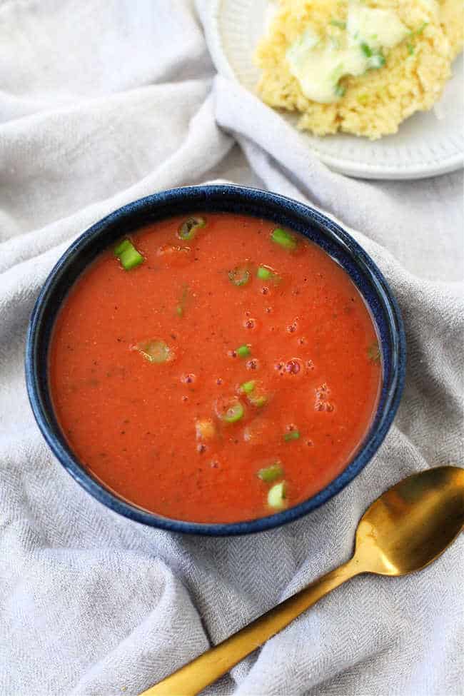creamy dairy free tomato soup in a blue ceramic bowl