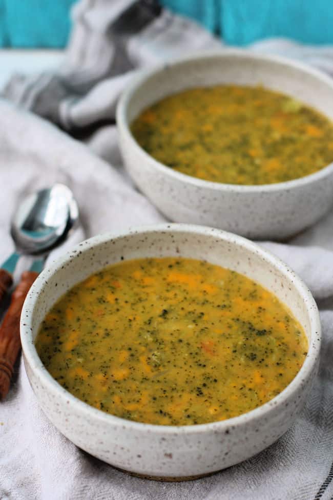 vegan cheesy broccoli soup in pottery bowls