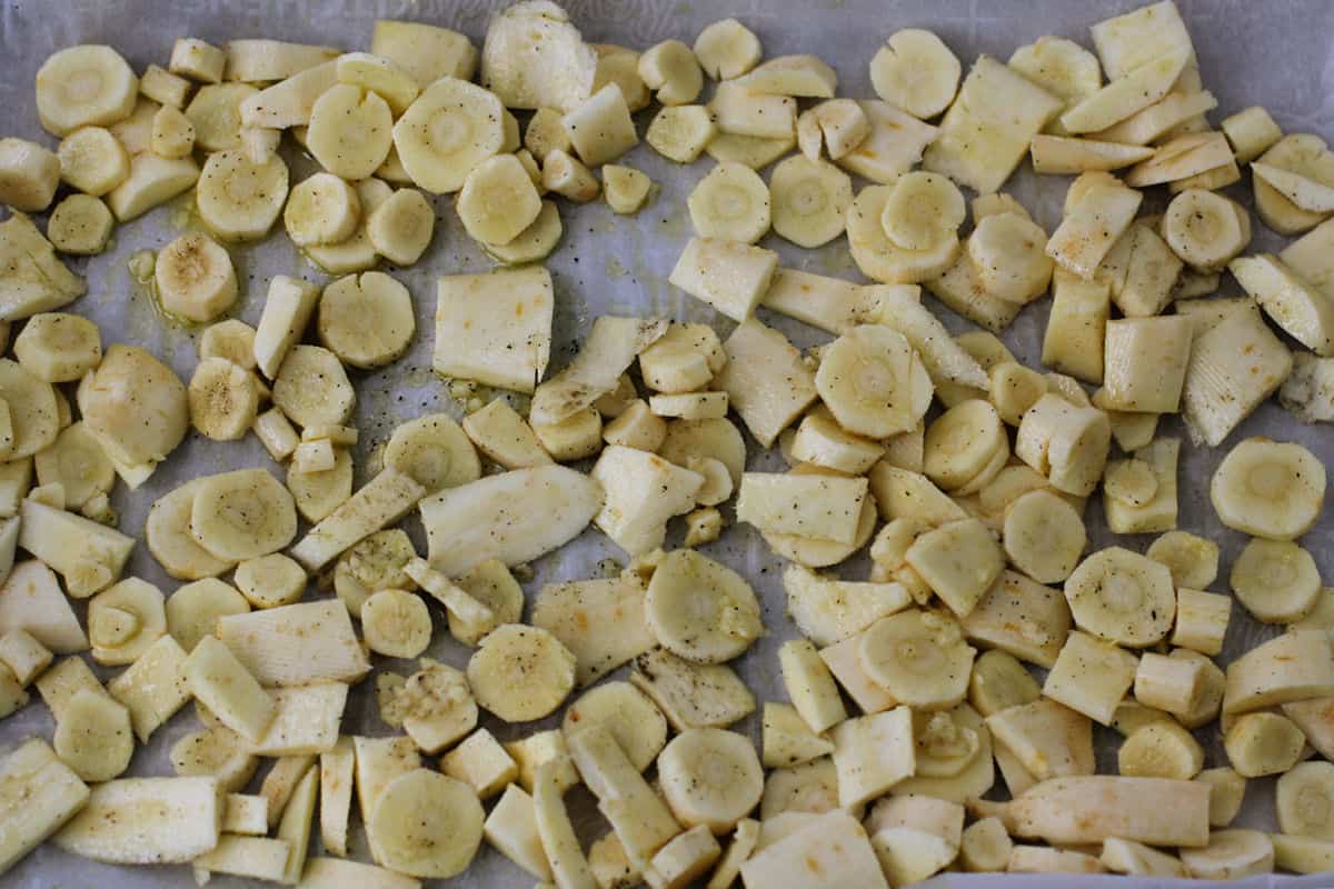 uncooked parsnips on a baking sheet