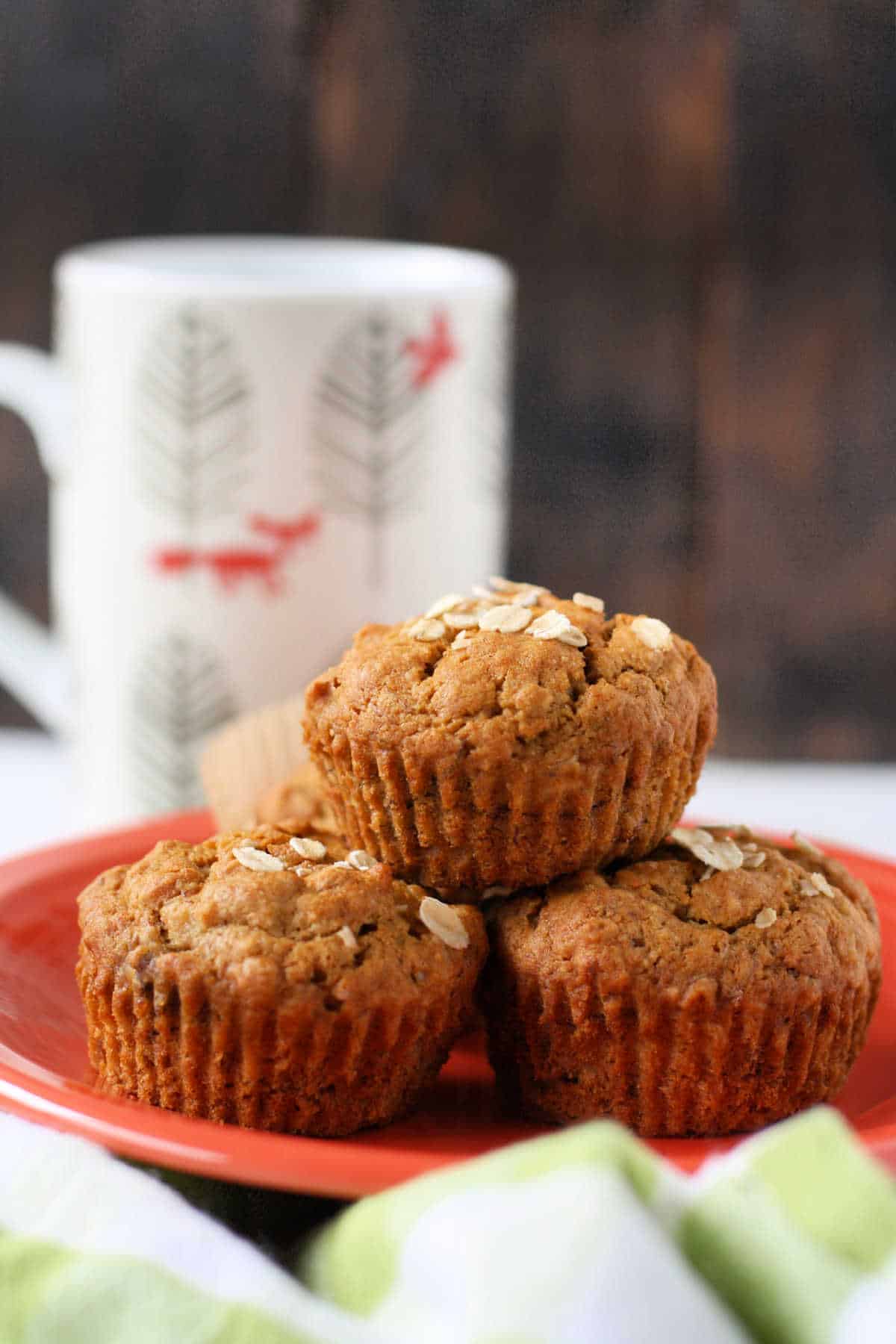 vegan banana oat muffins stacked on a plate