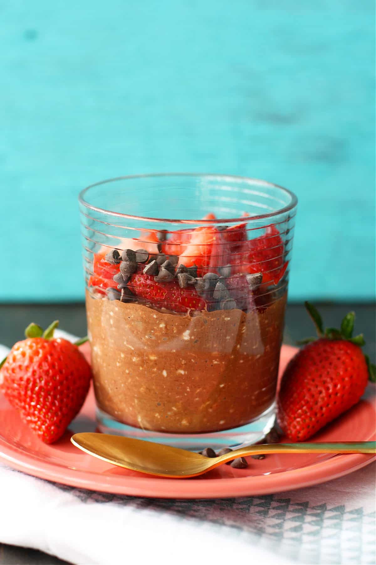 vegan chocolate overnight oats with berries in a glass jar
