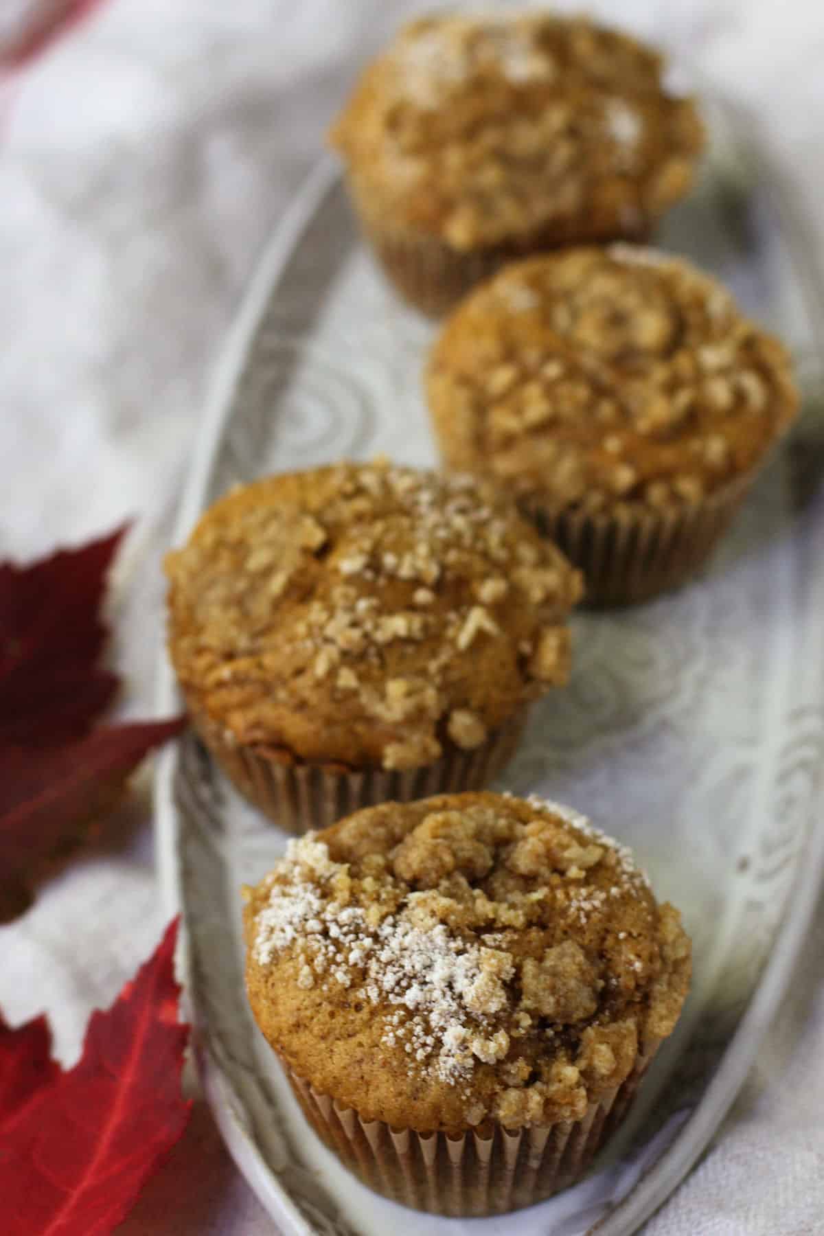 vegan pumpkin muffins on a light grey tray