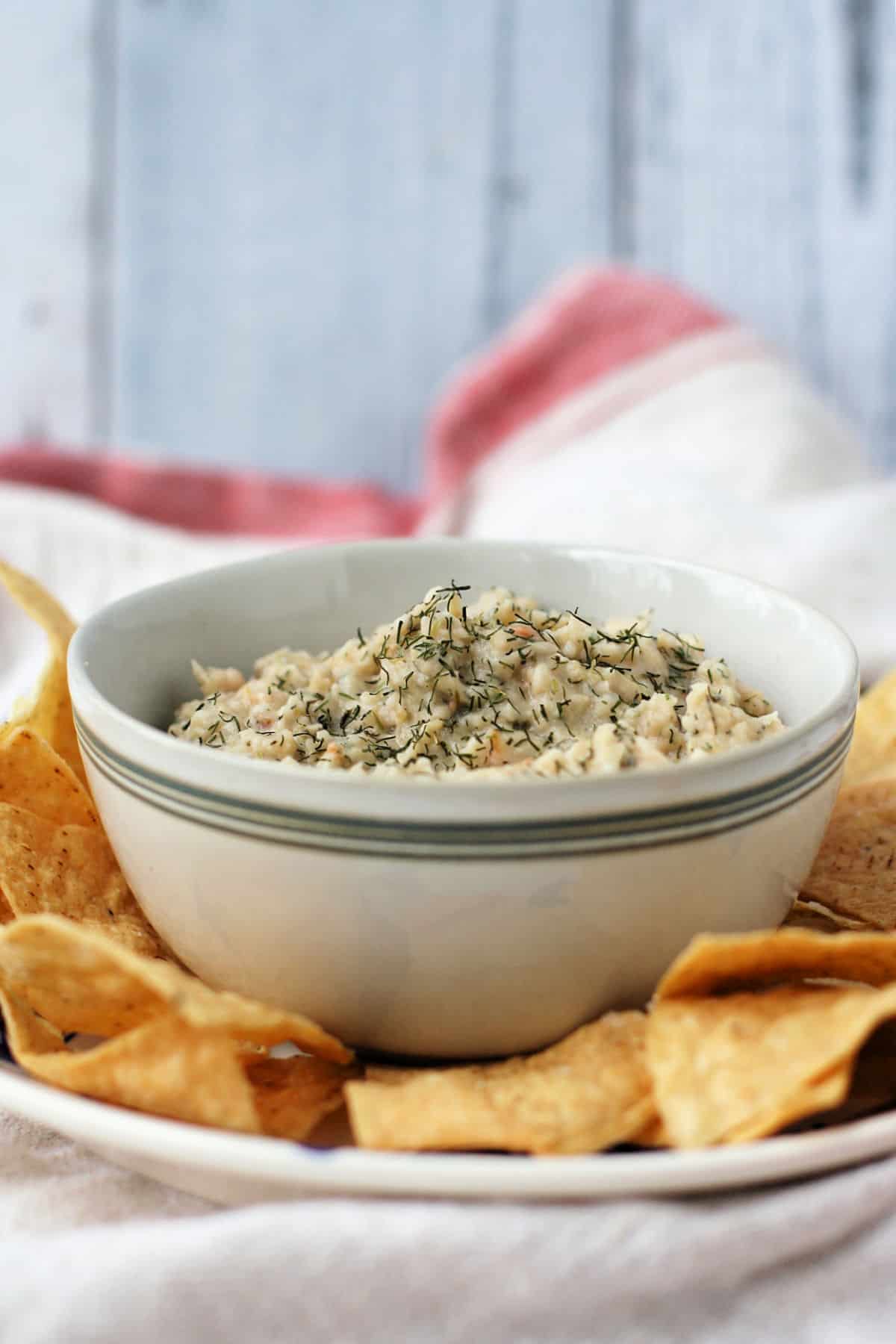 vegan white bean dip in a bowl with chips