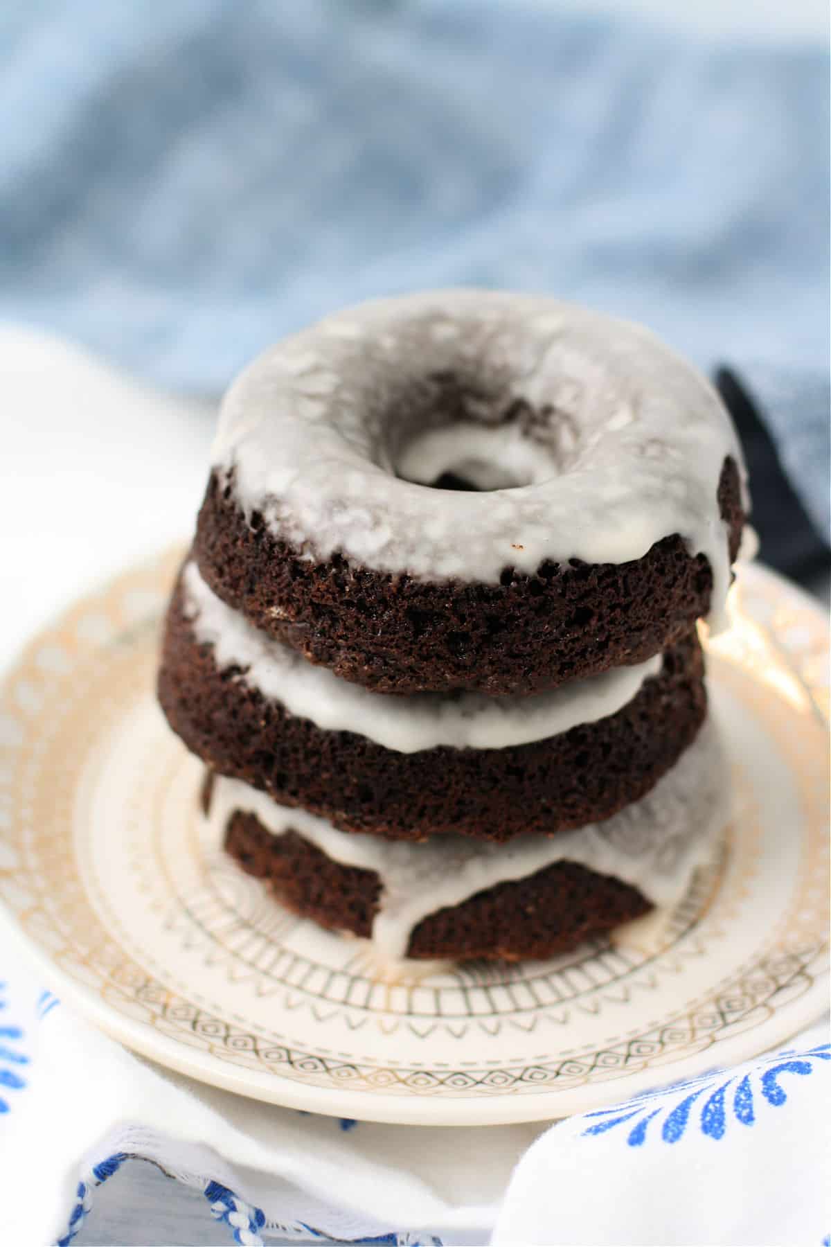 stack of gluten free chocolate donuts on a plate