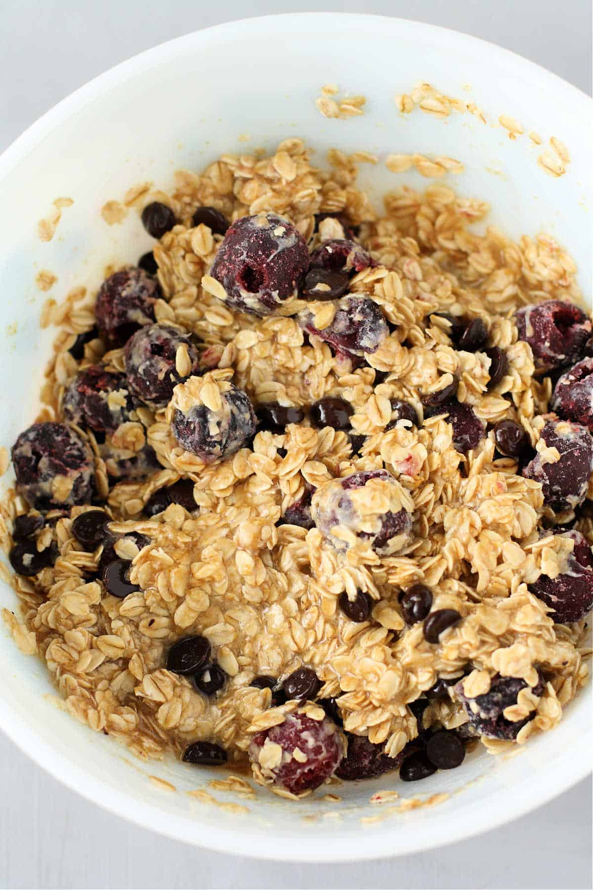oatmeal with cherries in a white bowl