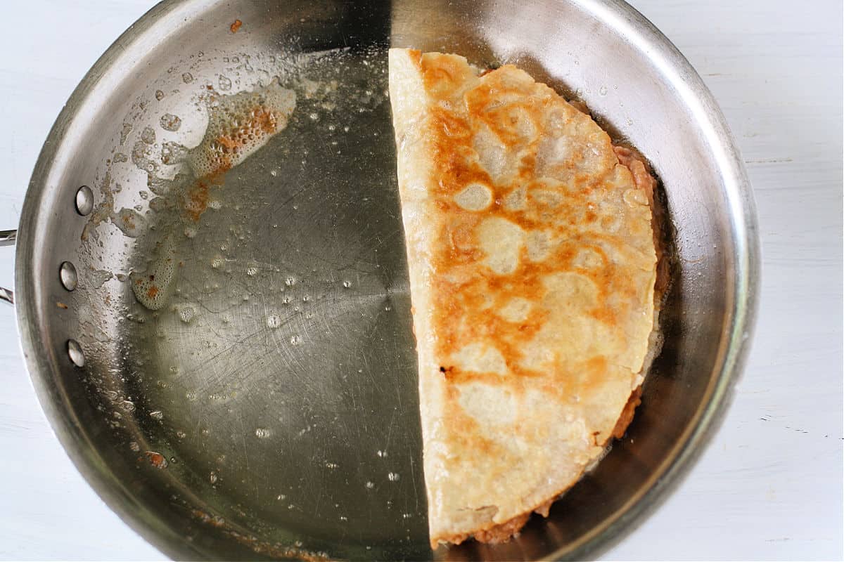 quesadilla cooking in pan